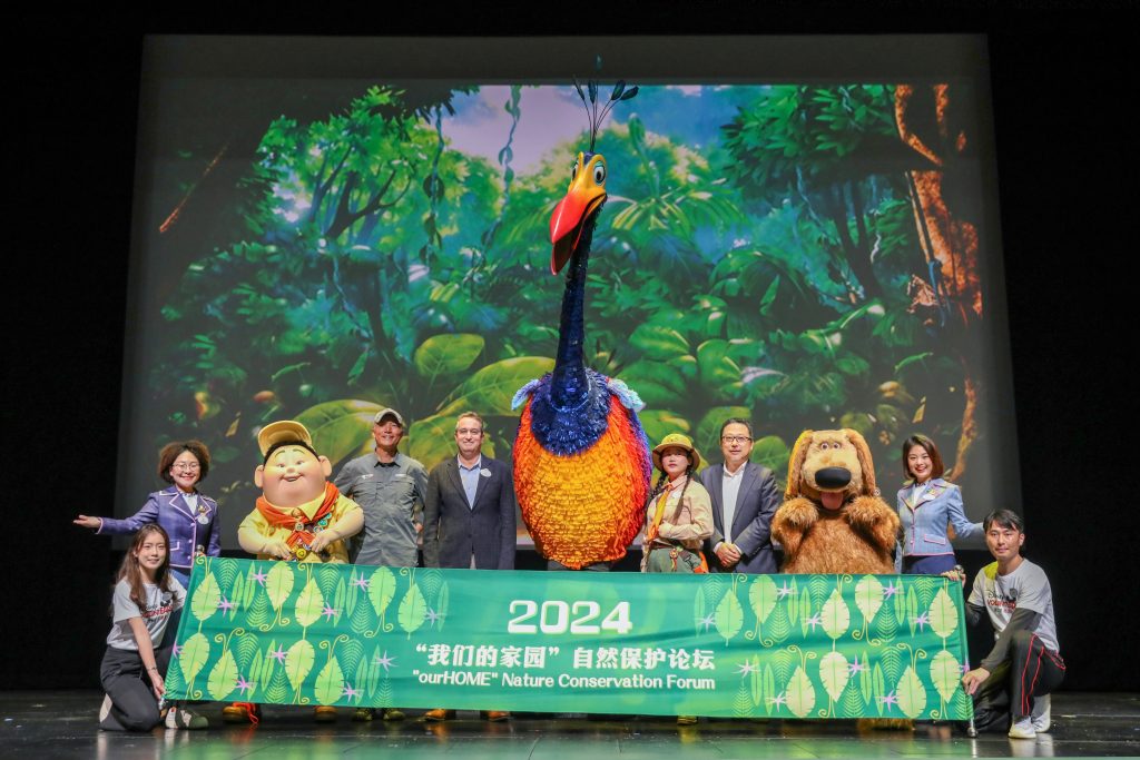 Group poses with characters from Pixar's "UP"