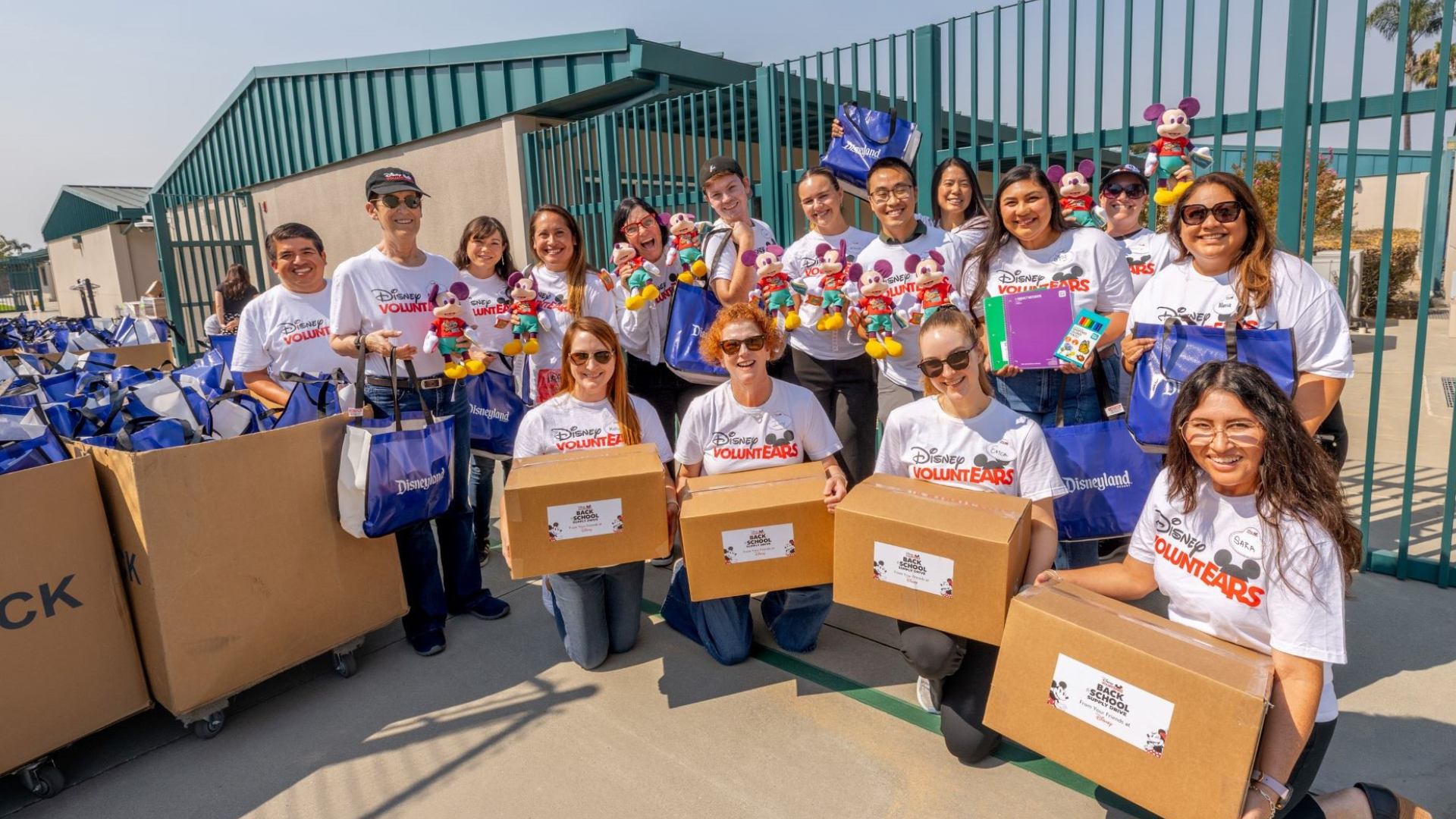 Disney VoluntEARS hold packages that they've made for teachers.