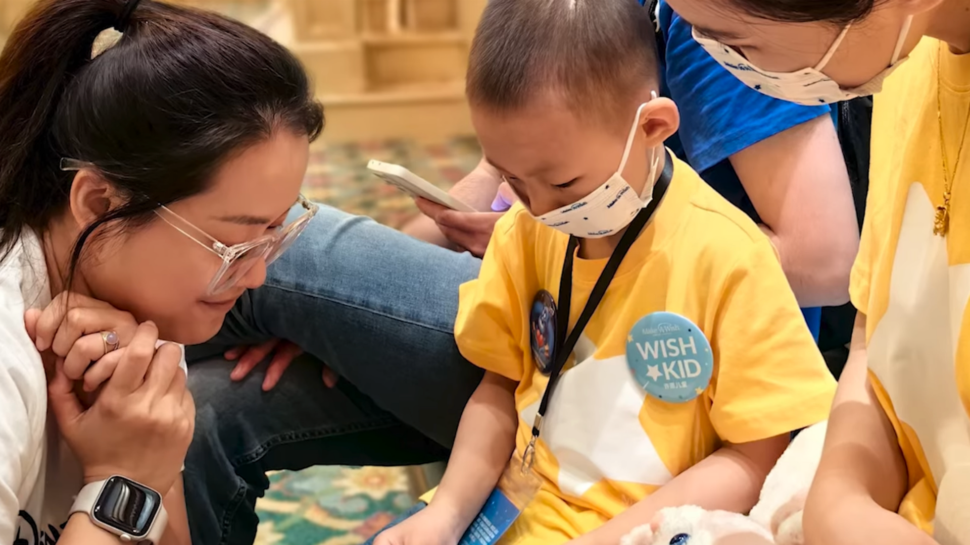 A wish kid in a mask looks down