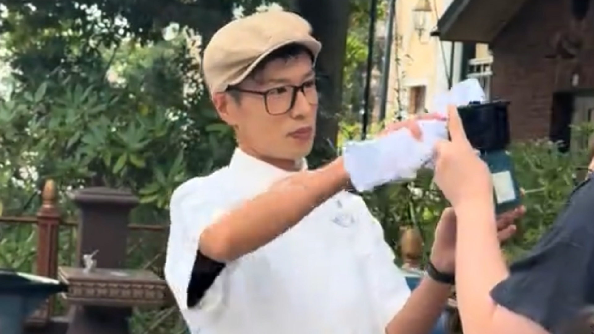 A Disney cast member wears all white.