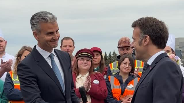 Josh D'Amaro shakes hands with Emmanuel Macron