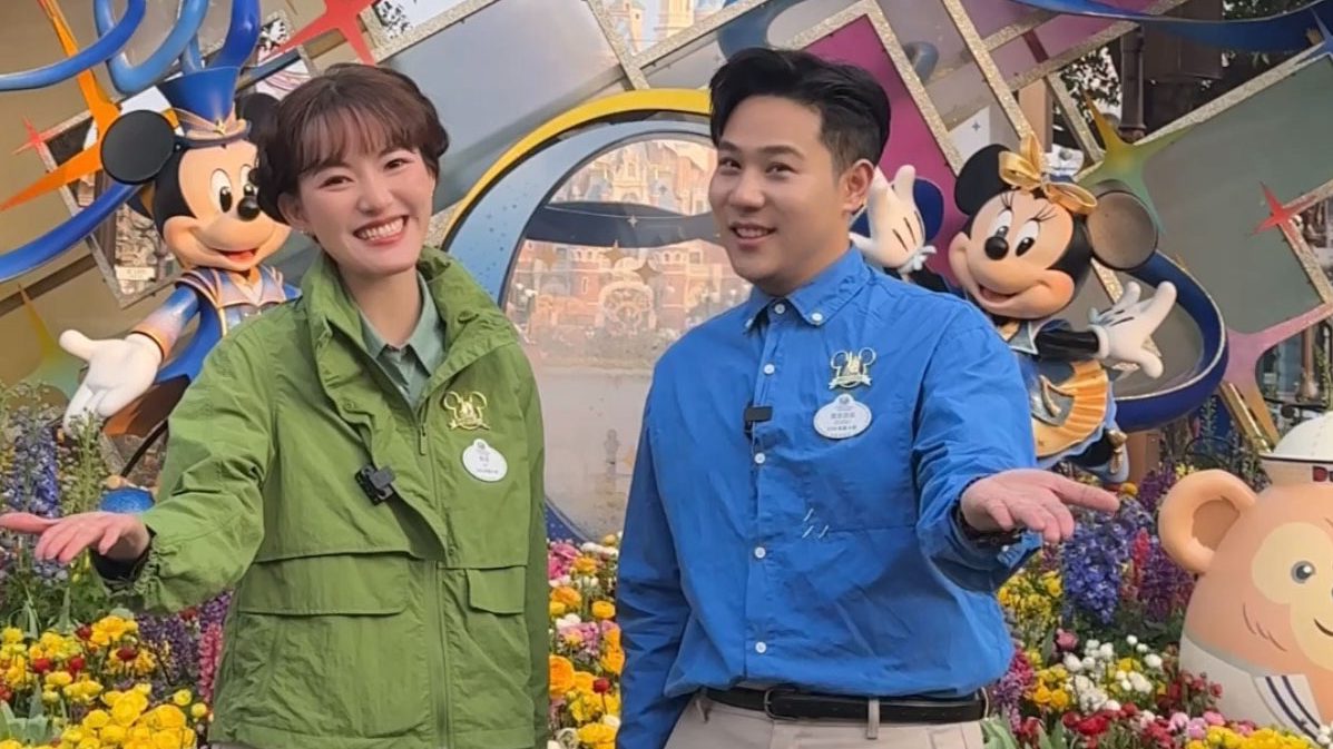 Two Cast Members smiling and reaching out
