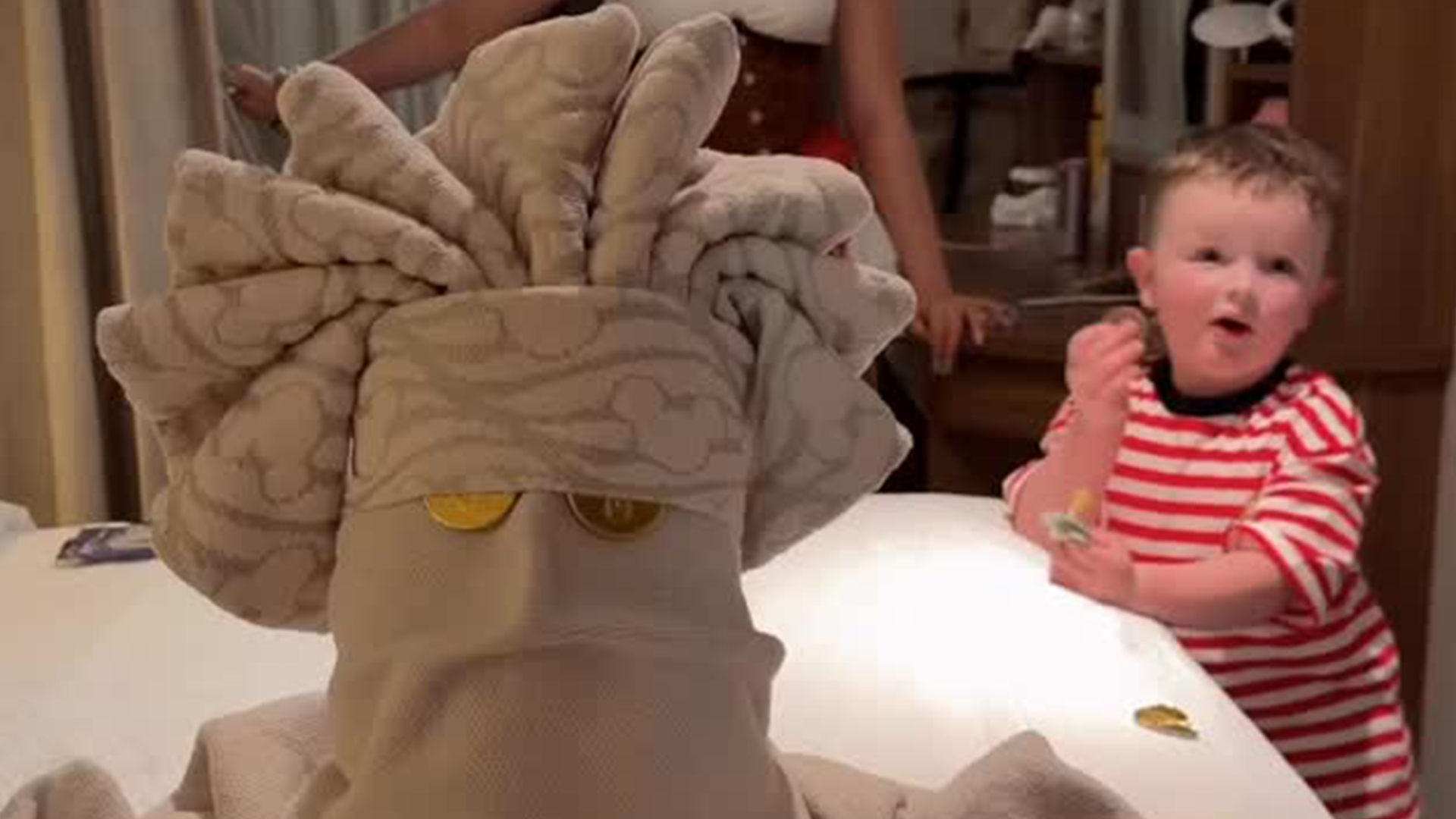 A child enjoys towel folded like animal