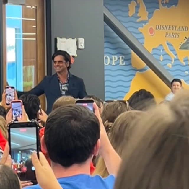 John Stamos walking into a room