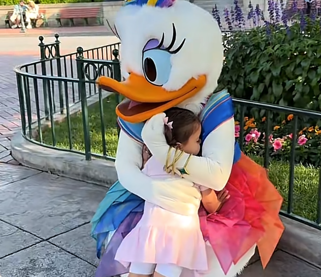 Little girl hugging Daisy