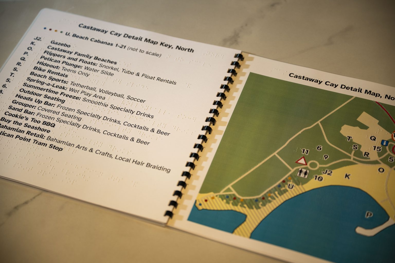 A braille and tactile guidebook for Disney Castaway Cay, with a map key and a raised map