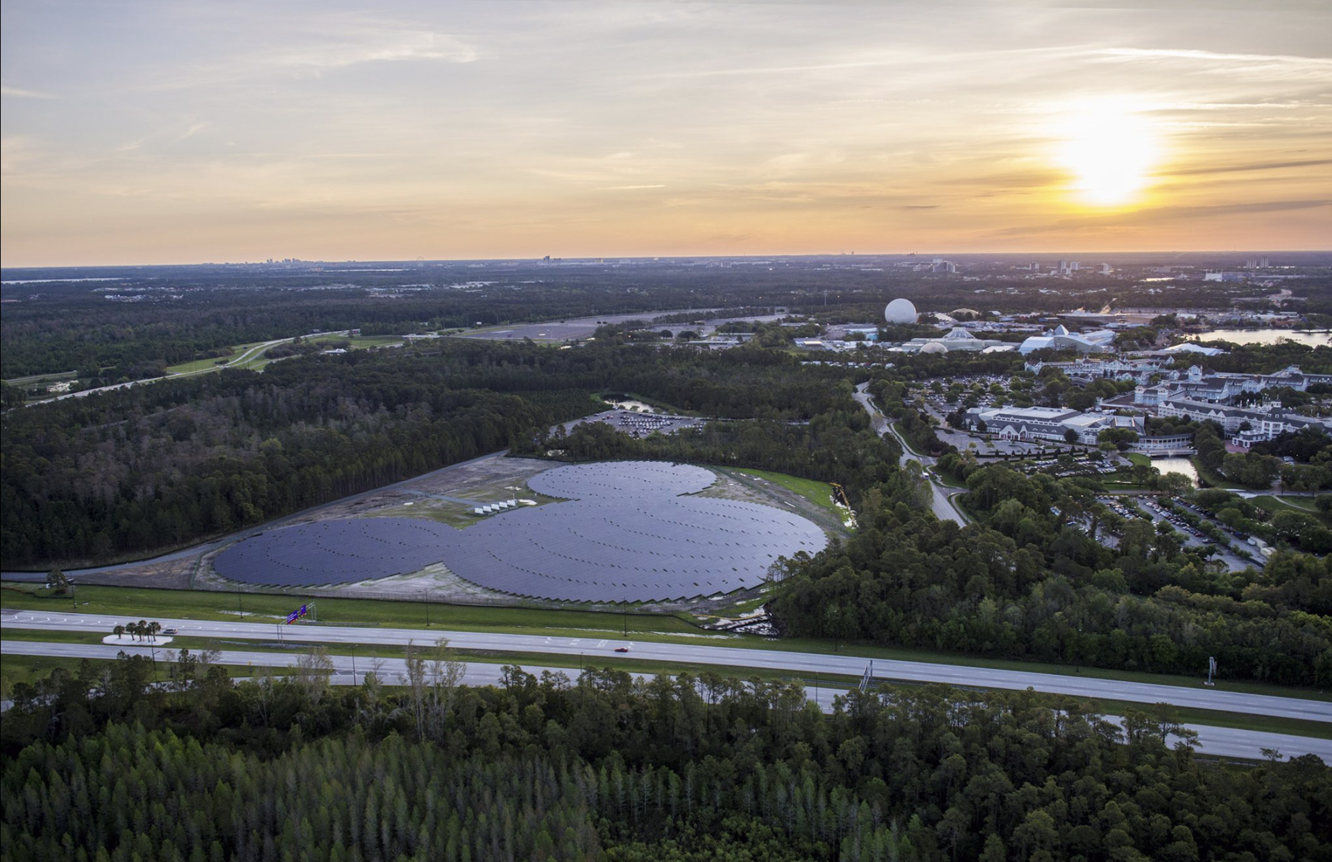 A landscape aerial image of a large Mickey Mouse-shaped solar array.