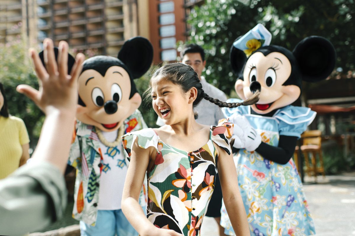 Mickey and Minnie dancing with girl at Aulani.