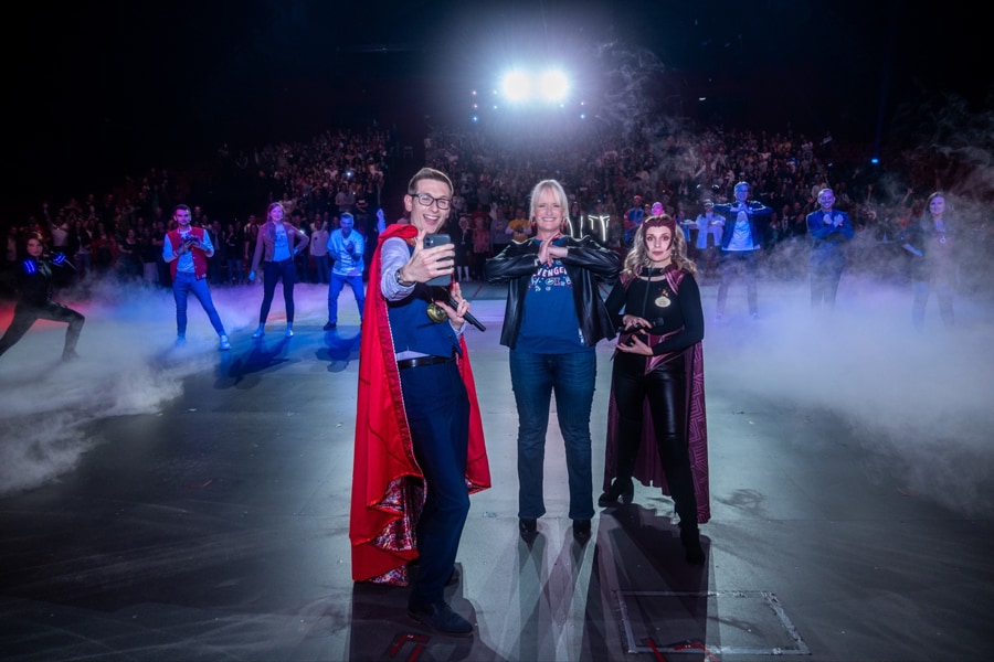 Disneyland Paris Ambassadors onstage taking a selfie dressed in Marvel costumes.