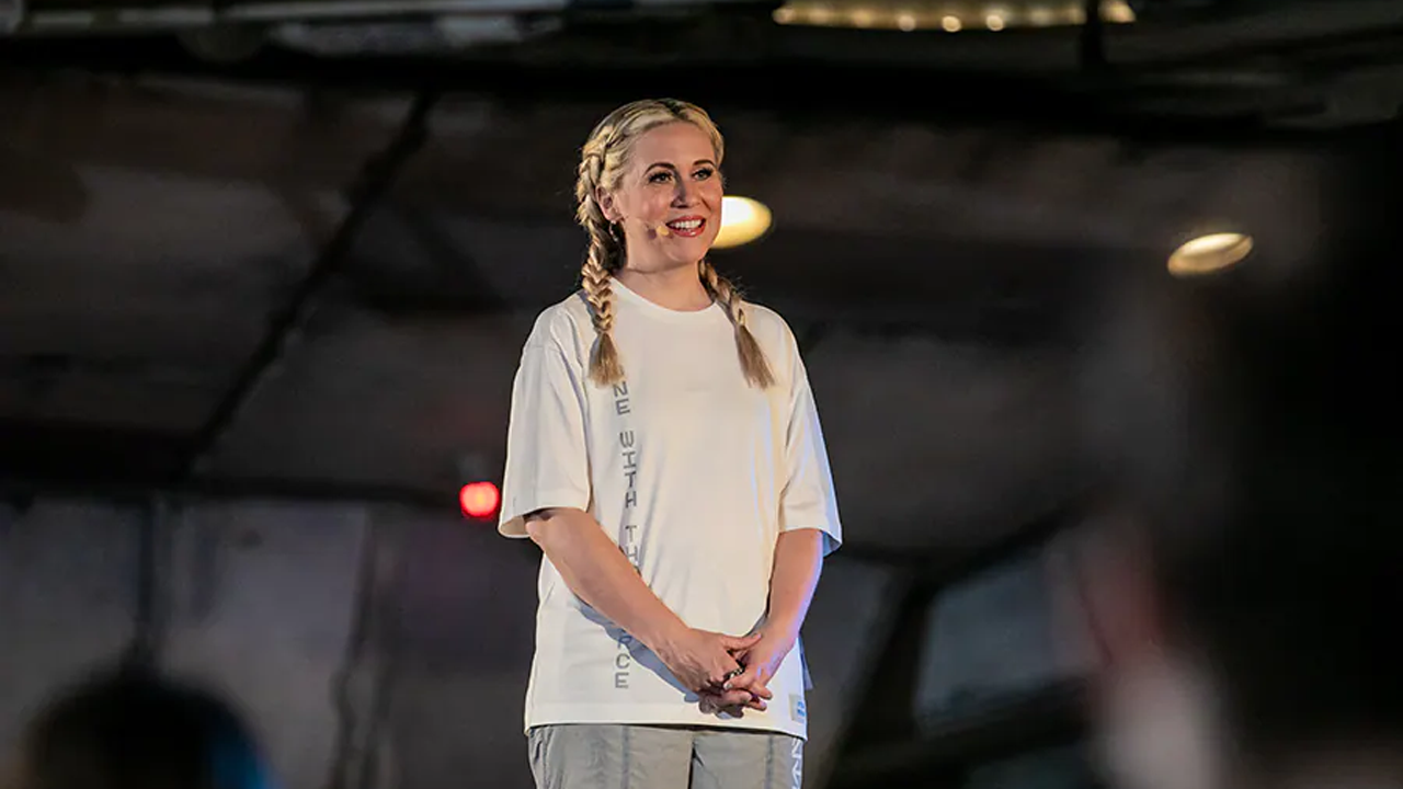 Ashley on stage wearing Her Universe clothing. 