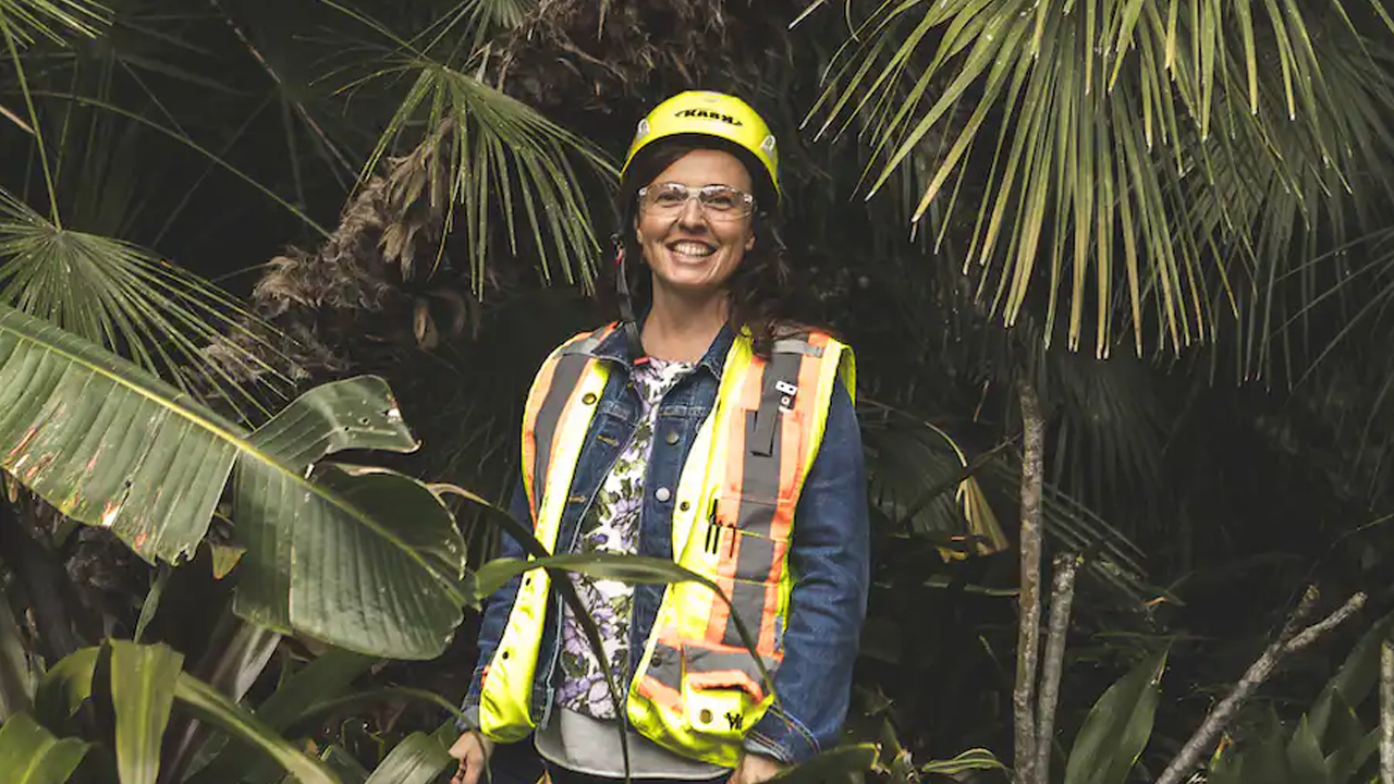 Rhonda Wood in PPE standing amongst the trees. 