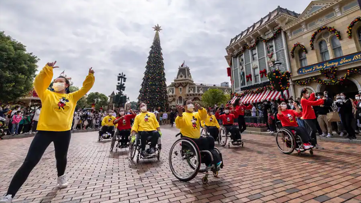 People in wheelchairs in the parade.