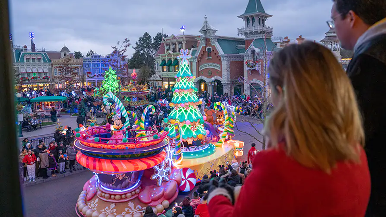 Disneyland Paris Ambassadors watch the parade go down Main Street.