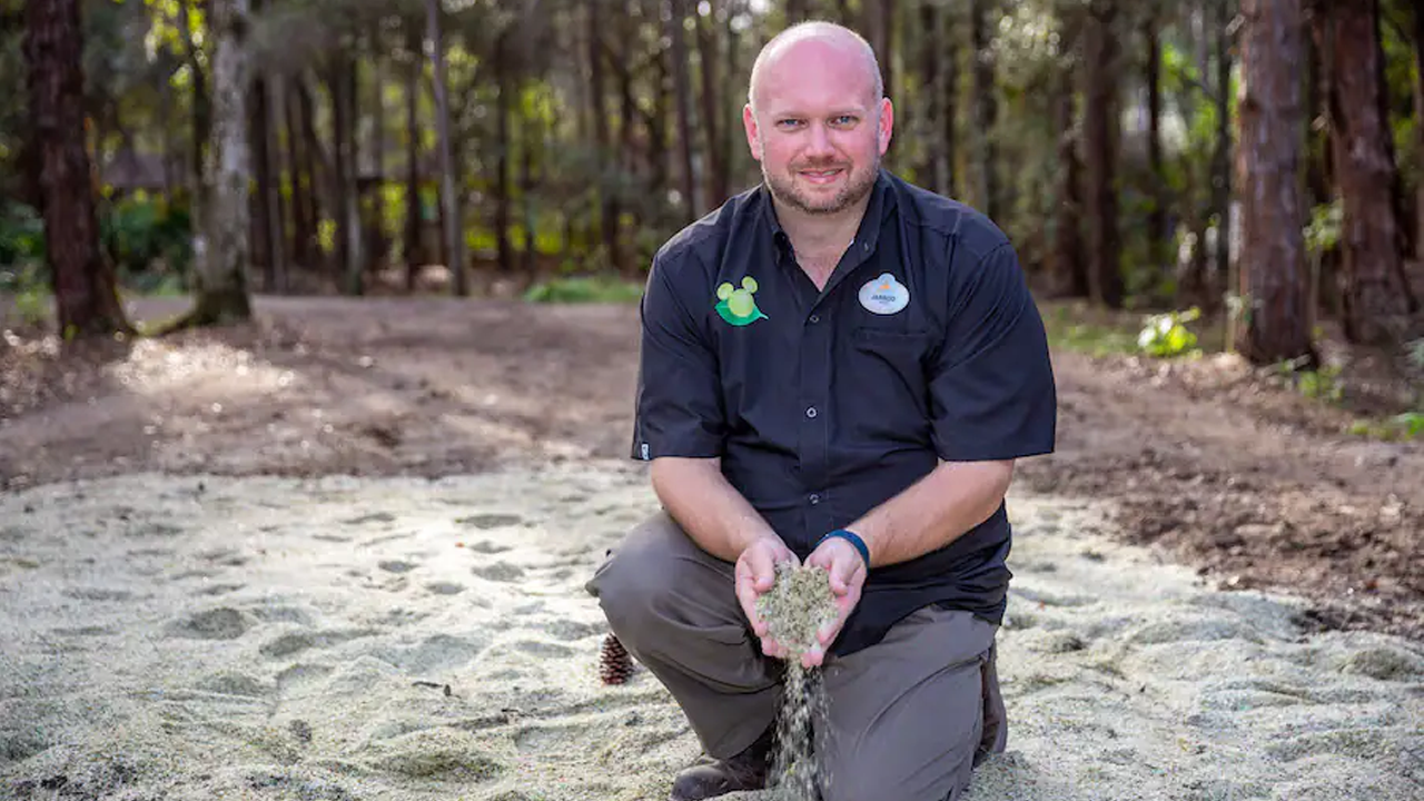 Man holding the glass sand in his hands. 