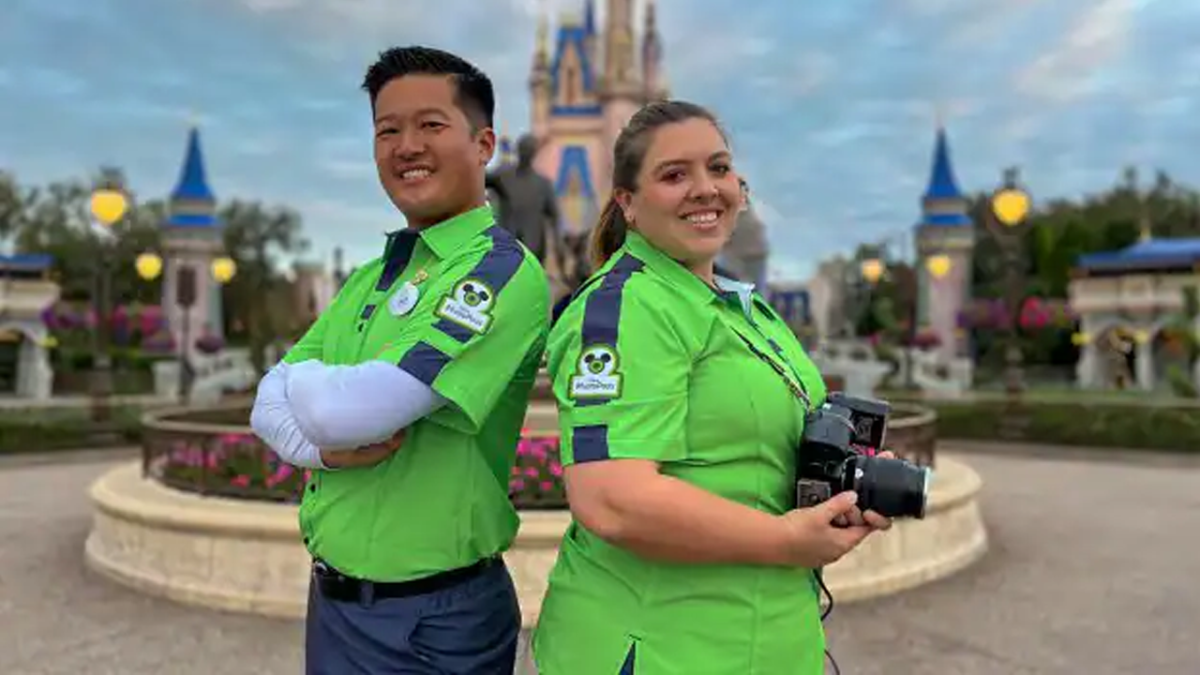 Two Photopass Photographers showing off their new costumes at Magic Kingdom.