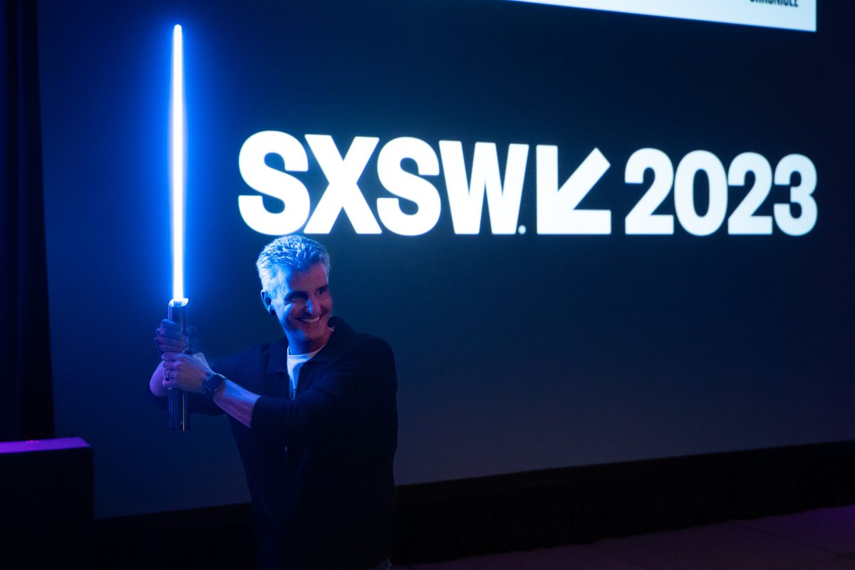 Josh D'Amaro holding a light saber at SXSW