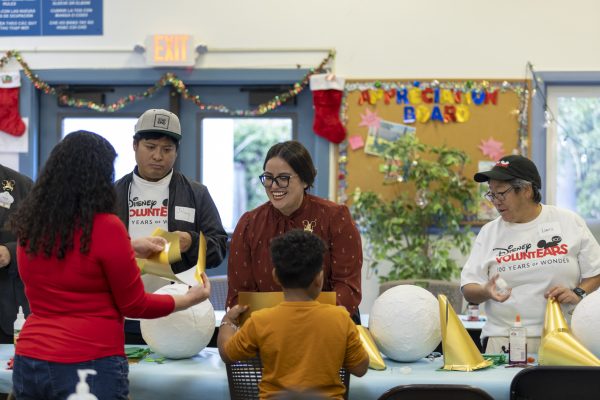 Disney ambassadors create holiday crafts with members of the community