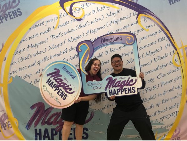 man and woman pictured holding props at Disneyland service celebration