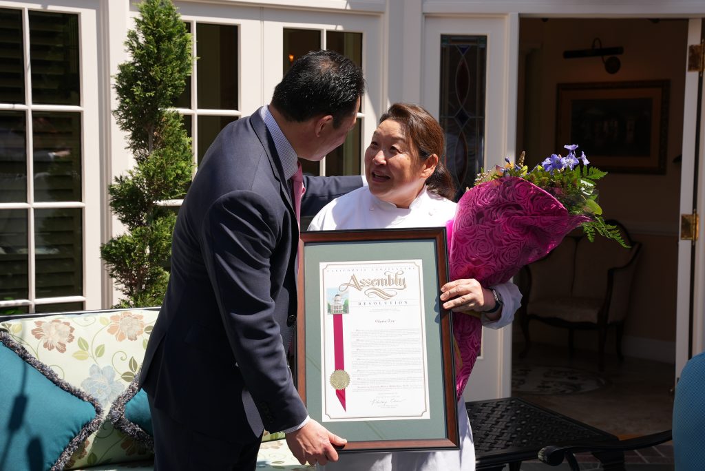 California State Assemblymember Philip Chen giving Chef Gloria her recognition.