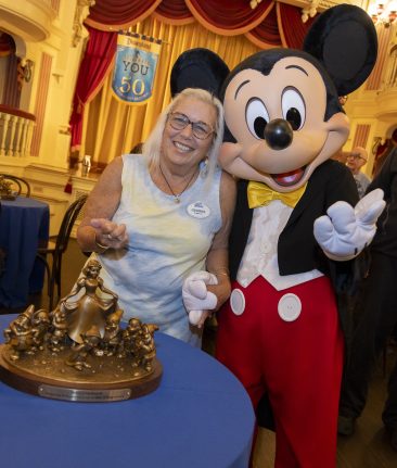 50-year Service Award recipient Debby 'Gehrke' McDowell with Mickey Mouse at the recent Service Celebration.