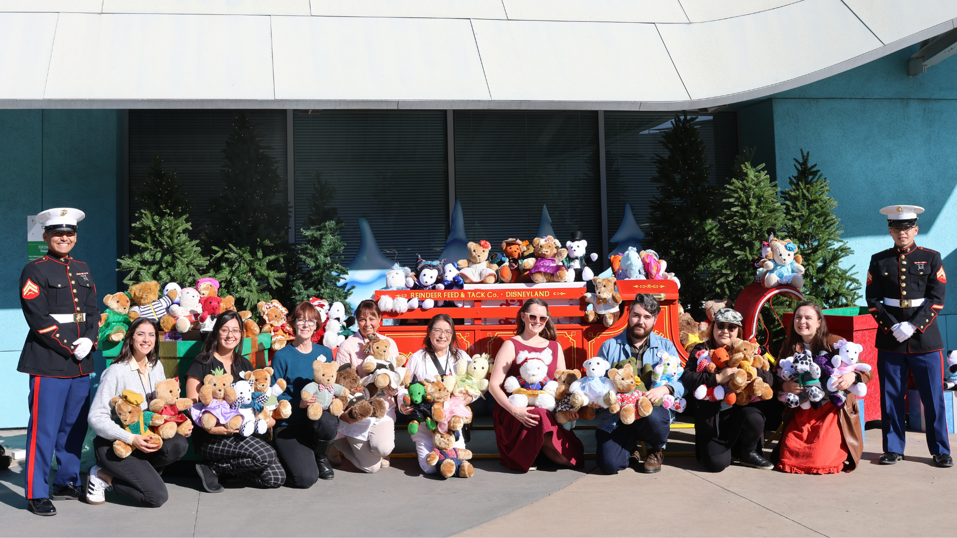 Cast members in the Costuming department with handmade bears their team created in donation to Toys for Tots. Each bear was crafted from costumes with repurposed fabric to create new one-of-a-kind toys made with care for kids in need.
