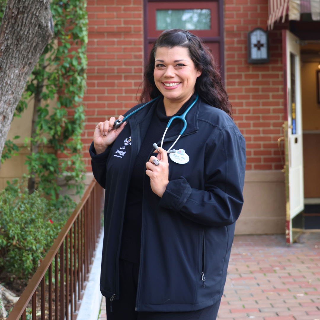 Cast member Samantha poses in front of the Disneyland park First Aid building.