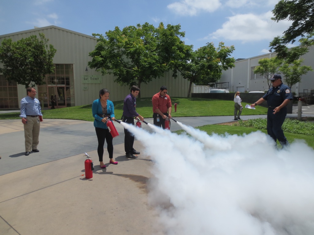 Cast members put their learnings to the test, practicing the PASS method using a real fire extinguisher.