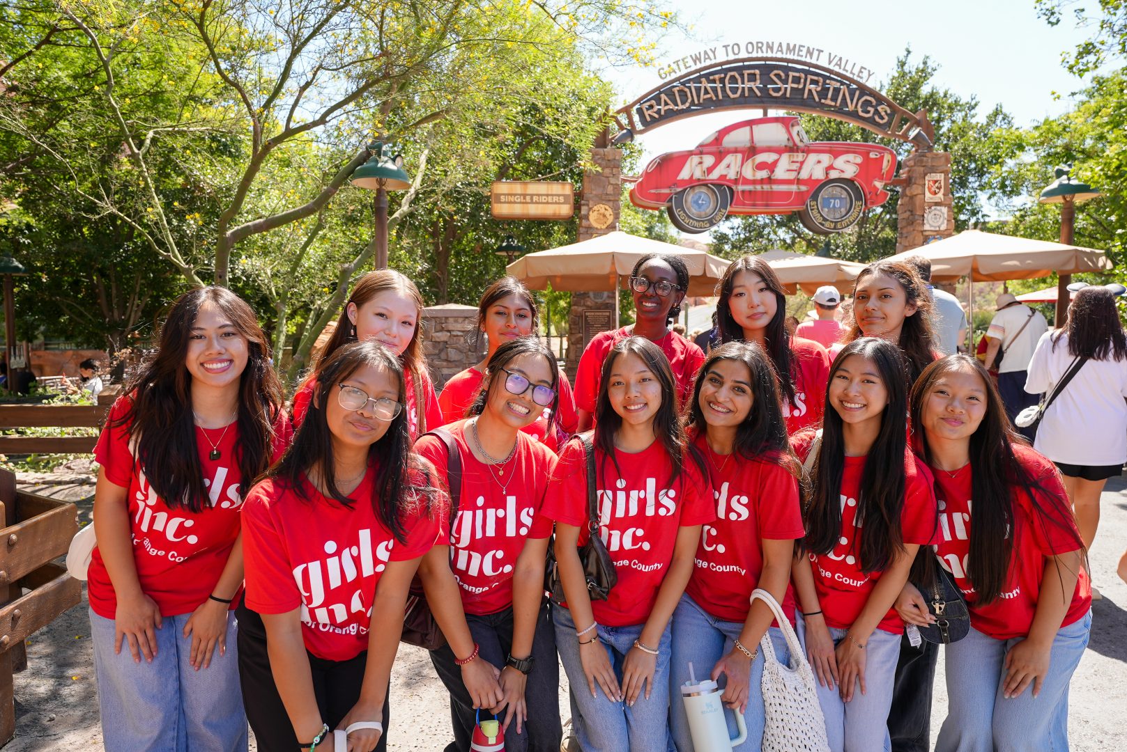 Participants in the 2025 cohort of Girls Inc. Of Orange County pose outside of Radiator Springs Racers.