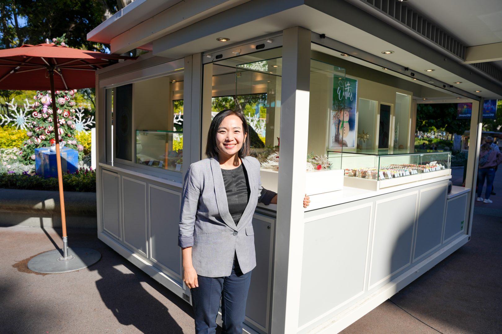 Kayla proudly smiles at the newly reimagined Kayla’s Cake cart in Downtown Disney District.