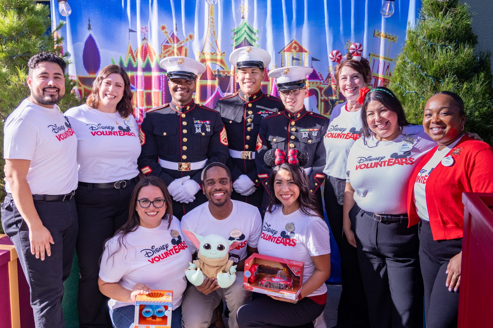 The “Ambassa-family” members who attended this year’s Toys for Tots volunteer event, posing with local members of the U.S. Marines.