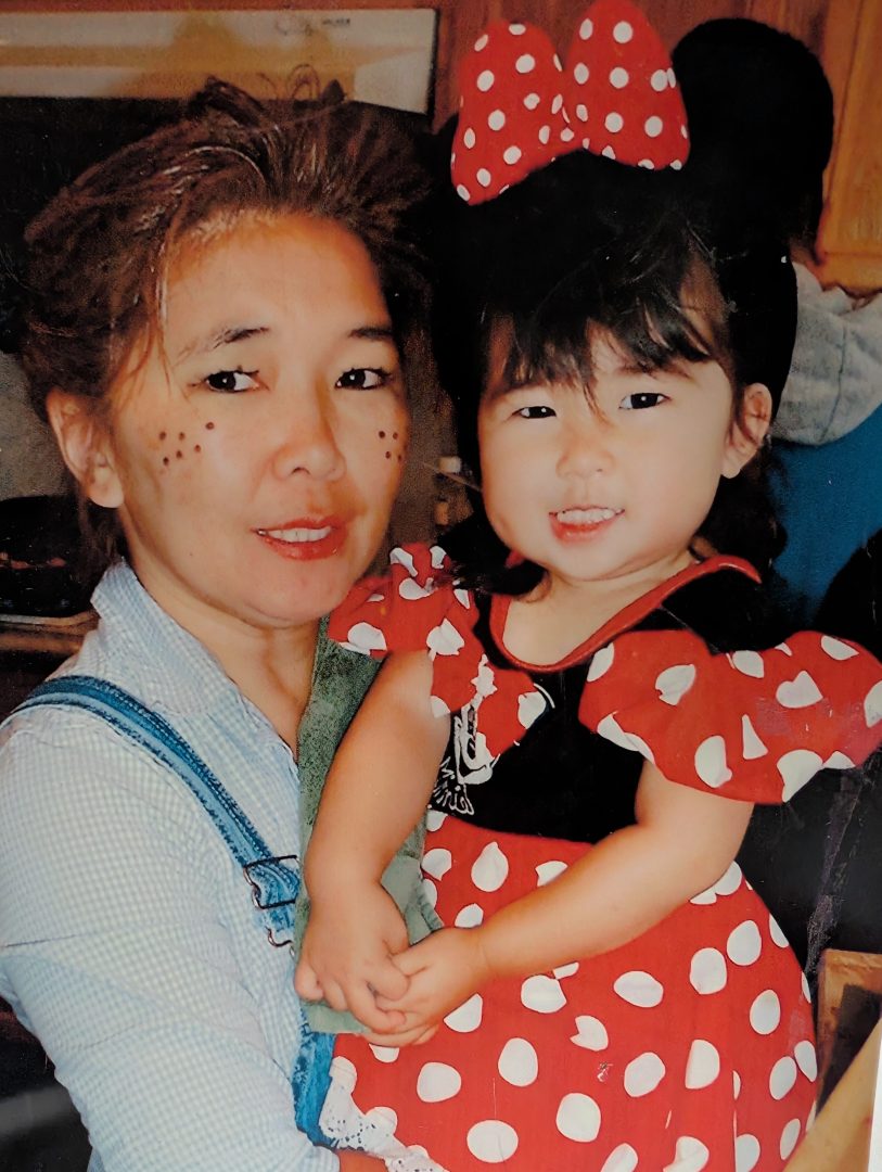Mary sports a Minnie Mouse costume while posing with her mom Diane on Halloween, loving Disney from a young age.