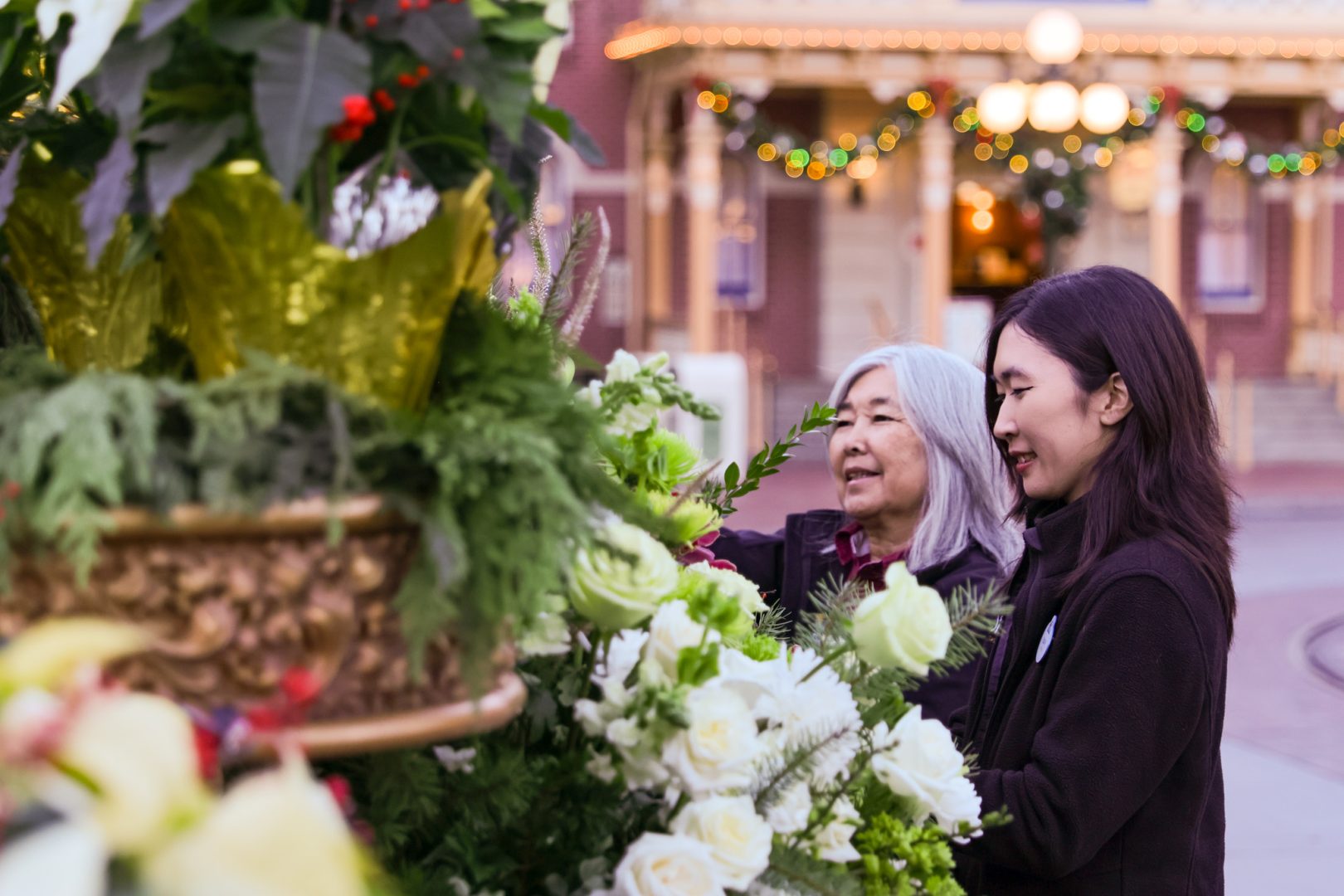 Diane and Mary working together with the live florals they love so much on the Candlelight Processional stage.