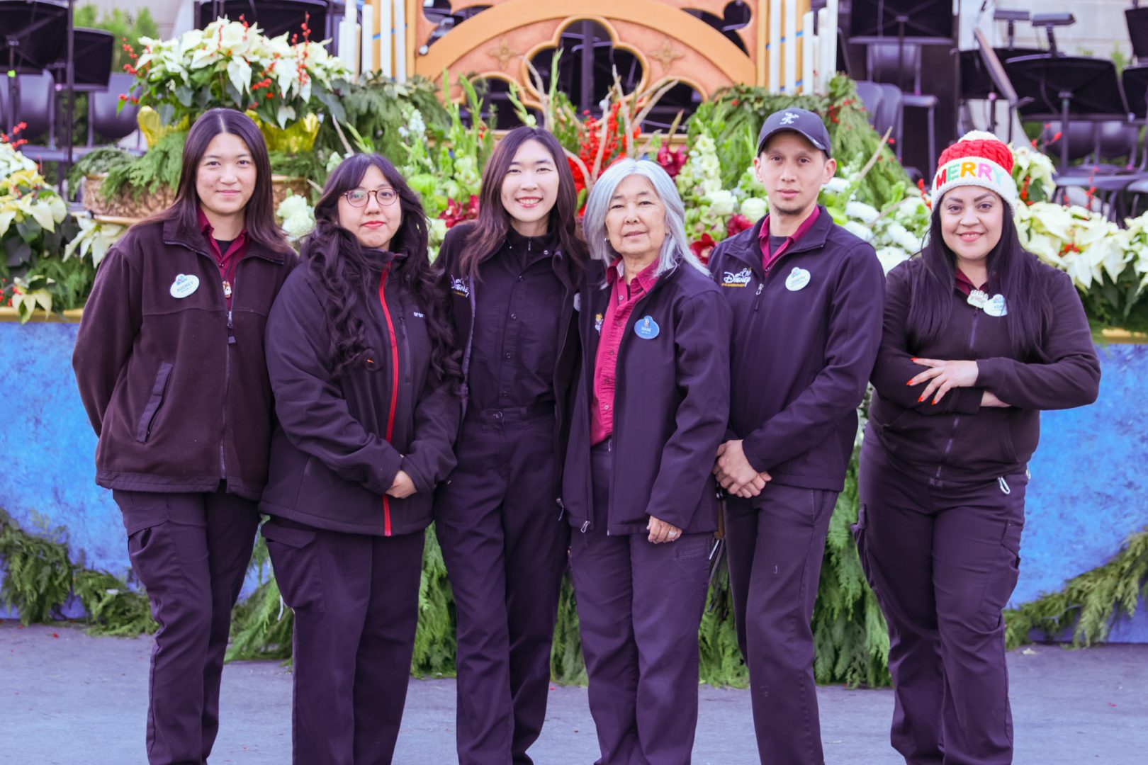 Diane and Mary pose with their teammates, who all worked together to beautifully decorate the Candlelight Processional stage this year.