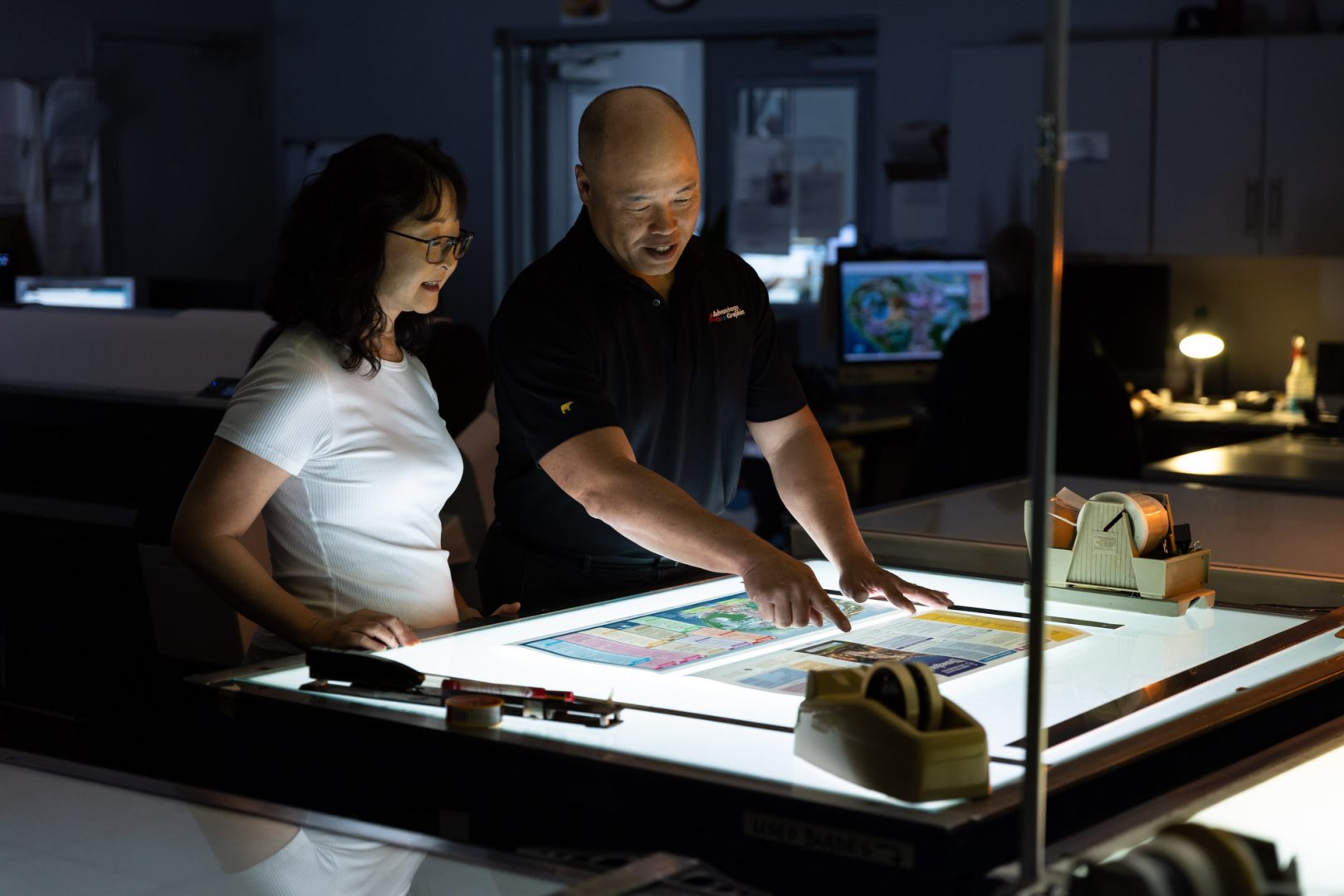 Tom (right) works with one of his team members on refining a recent map design.