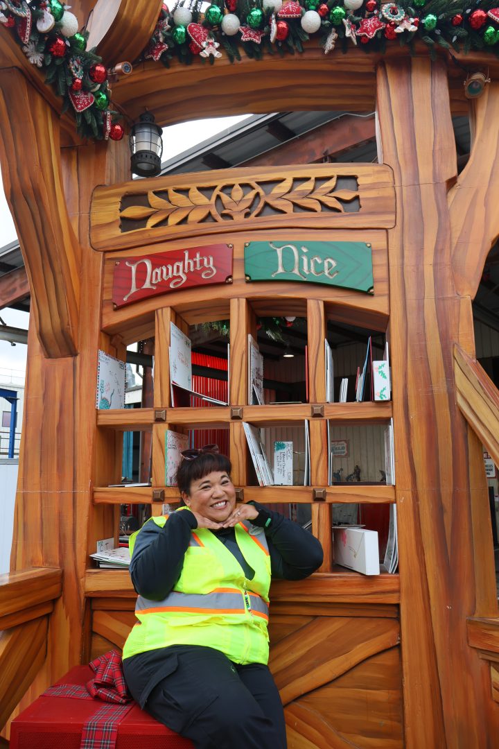 Ken and Christine posing on floats they have driven in "A Christmas Fantasy Parade" this season.