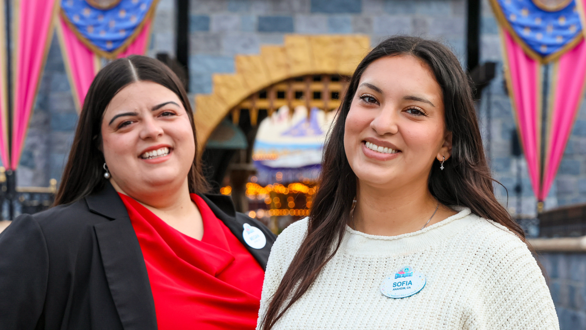 Cast Members smiling in front of Sleeping Beauty Castle.
